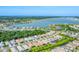 A scenic aerial view showcasing a sprawling community near a lake, with well-maintained houses and lush greenery at 8069 Tidal Pointe Way, Sarasota, FL 34240