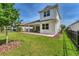 Beautiful backyard with covered patio, green lawn, and landscaping that offers great curb appeal at 8069 Tidal Pointe Way, Sarasota, FL 34240