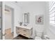 Well-lit bathroom featuring modern fixtures, ample lighting, and patterned tile floor at 8069 Tidal Pointe Way, Sarasota, FL 34240