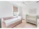 Inviting bedroom featuring a daybed, crib, a large window, and hardwood floors at 8069 Tidal Pointe Way, Sarasota, FL 34240