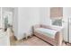Charming bedroom featuring a daybed, a large window, and hardwood floors at 8069 Tidal Pointe Way, Sarasota, FL 34240