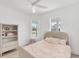 Bright bedroom featuring a twin bed, bright windows, and hardwood floors at 8069 Tidal Pointe Way, Sarasota, FL 34240