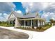 An exterior shot of the clubhouse with a stone facade, white trim, and covered porch at 8069 Tidal Pointe Way, Sarasota, FL 34240