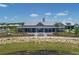 Beautiful community clubhouse featuring inviting outdoor space, professional landscaping, and community areas at 8069 Tidal Pointe Way, Sarasota, FL 34240