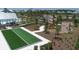 An aerial view showcasing the community's amenities, including a pool, playground, bocce ball court, and lush landscaping at 8069 Tidal Pointe Way, Sarasota, FL 34240