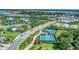 An aerial showcases the community's tennis and pickleball courts, lake, clubhouse, and beautiful surrounding homes at 8069 Tidal Pointe Way, Sarasota, FL 34240