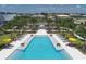 Community pool and lounge chairs with pergolas at 8069 Tidal Pointe Way, Sarasota, FL 34240