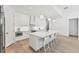 Modern kitchen features a large center island with seating, stainless steel appliances, and contemporary design at 8069 Tidal Pointe Way, Sarasota, FL 34240