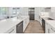 Spacious kitchen with white cabinets, hardwood floors, stainless steel appliances, and a large kitchen island at 8069 Tidal Pointe Way, Sarasota, FL 34240