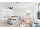 Spacious living room featuring a large sectional, tent, and well-lit windows at 8069 Tidal Pointe Way, Sarasota, FL 34240