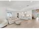 Open-concept living space showcasing a modern kitchen, dining area, and a comfortable living room setup at 8069 Tidal Pointe Way, Sarasota, FL 34240