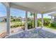 The view from a covered patio, featuring elegant columns and a serene outdoor setting at 8069 Tidal Pointe Way, Sarasota, FL 34240