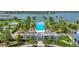 A beautiful pool with palm trees and lounge chairs overlooking a large lake in the community at 8069 Tidal Pointe Way, Sarasota, FL 34240