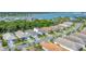 An aerial view of a residential street with well-maintained homes and lush landscaping near the water at 8069 Tidal Pointe Way, Sarasota, FL 34240