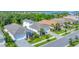 Beautiful street view of well-maintained homes with lush landscaping and well manicured lawns near the water at 8069 Tidal Pointe Way, Sarasota, FL 34240