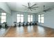 An airy yoga room with wood floors, large windows, and stationary bikes for exercise at 8069 Tidal Pointe Way, Sarasota, FL 34240