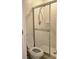 Bathroom featuring a shower with glass doors and a toilet with a closed lid at 8755 Olde Hickory Ave # 7107, Sarasota, FL 34238