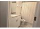 Bright bathroom features a granite countertop vanity, with neutral colors and a shower with a curtain at 8755 Olde Hickory Ave # 7107, Sarasota, FL 34238