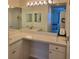 Bathroom featuring vanity with dual mirrors, ample counter space and a sink with a chrome faucet at 8755 Olde Hickory Ave # 7107, Sarasota, FL 34238