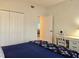 Bedroom featuring a blue bed, a built-in wardrobe and desk with storage drawers at 8755 Olde Hickory Ave # 7107, Sarasota, FL 34238