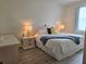 Comfortable bedroom featuring a white bed, stylish bedside tables, and a bright window at 8755 Olde Hickory Ave # 7107, Sarasota, FL 34238