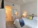 Comfortable bedroom featuring a white bed, stylish dresser, and with an ensuite bathroom at 8755 Olde Hickory Ave # 7107, Sarasota, FL 34238
