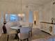 Dining area featuring a contemporary table setting and laminate flooring at 8755 Olde Hickory Ave # 7107, Sarasota, FL 34238