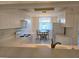 Kitchen featuring white appliances, cabinets, and a pass through window to the adjacent dining area at 8755 Olde Hickory Ave # 7107, Sarasota, FL 34238