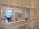 Kitchen featuring a pass-through bar with a dining area in the background at 8755 Olde Hickory Ave # 7107, Sarasota, FL 34238