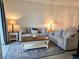 Cozy living room showcasing modern sofas, stylish lamps, and a decorative rug on wood floors at 8755 Olde Hickory Ave # 7107, Sarasota, FL 34238