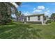 The backyard is beautifully landscaped and includes a screened-in patio, offering an outdoor retreat at 8979 Grey Oaks Ave, Sarasota, FL 34238