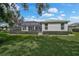 Well-maintained backyard with lush lawn and screened-in patio area is ideal for outdoor entertaining at 8979 Grey Oaks Ave, Sarasota, FL 34238