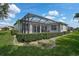 This home features a screened patio, perfect for enjoying the serene backyard and outdoor living at 8979 Grey Oaks Ave, Sarasota, FL 34238