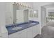 Bright bathroom featuring double sinks, a large mirror with lighting, and a shower at 8979 Grey Oaks Ave, Sarasota, FL 34238
