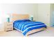 Bright bedroom featuring a bed with blue striped bedding and wooden nightstands at 8979 Grey Oaks Ave, Sarasota, FL 34238