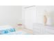 This bedroom features twin beds, a white wicker dresser, and a chair at 8979 Grey Oaks Ave, Sarasota, FL 34238