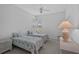 Bright bedroom featuring two twin beds, a window with blinds, and a ceiling fan at 8979 Grey Oaks Ave, Sarasota, FL 34238