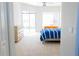 Bright bedroom with carpet and sliding door to the outside at 8979 Grey Oaks Ave, Sarasota, FL 34238