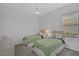 Bright bedroom with two beds, a window with blinds, and ceiling fan at 8979 Grey Oaks Ave, Sarasota, FL 34238