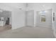 Spacious carpeted bedroom adjacent to the kitchen, featuring a large closet at 8979 Grey Oaks Ave, Sarasota, FL 34238