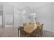 Light dining room featuring a wooden table set, tile flooring, and natural light at 8979 Grey Oaks Ave, Sarasota, FL 34238