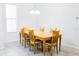 Well-lit dining area features a wooden table with six chairs and tile flooring at 8979 Grey Oaks Ave, Sarasota, FL 34238