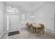Dining room with neutral tile floor, a matching dining set, and high ceilings at 8979 Grey Oaks Ave, Sarasota, FL 34238
