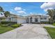 Home exterior boasts an attached garage and a patterned concrete driveway at 8979 Grey Oaks Ave, Sarasota, FL 34238