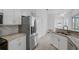 Bright kitchen featuring stainless steel appliances and breakfast bar at 8979 Grey Oaks Ave, Sarasota, FL 34238
