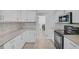 Close-up of modern kitchen featuring stainless steel appliances and light countertops at 8979 Grey Oaks Ave, Sarasota, FL 34238