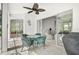 Lanai featuring a table, chairs, ceiling fan, and sliding glass doors to the interior at 8979 Grey Oaks Ave, Sarasota, FL 34238