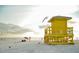 Scenic beach scene with a lifeguard station on a sunny day, capturing the essence of coastal living at 8979 Grey Oaks Ave, Sarasota, FL 34238