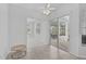 Bright, carpeted living room with sliding glass doors to outdoor patio at 8979 Grey Oaks Ave, Sarasota, FL 34238