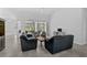 Living area with tile flooring, comfortable seating, and sliding glass doors at 8979 Grey Oaks Ave, Sarasota, FL 34238